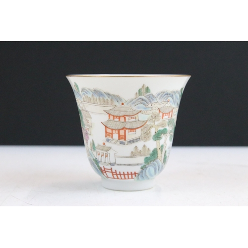 43 - 19th Century Chinese cup and saucer each being enamelled with mountainous pagoda scenes in red, gree... 