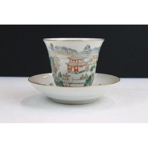 43 - 19th Century Chinese cup and saucer each being enamelled with mountainous pagoda scenes in red, gree... 