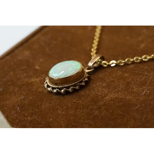 199 - A 9ct gold white opal pendant on 9ct gold chain link necklace within display case.