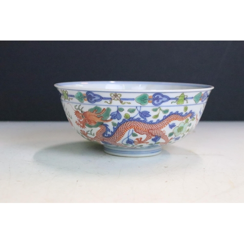 47 - Pair of Chinese Guangxu Wucai white porcelain bowls each being hand enamelled with dragons chasing f... 