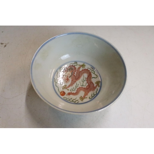 47 - Pair of Chinese Guangxu Wucai white porcelain bowls each being hand enamelled with dragons chasing f... 