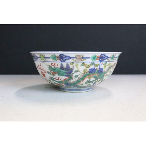 47 - Pair of Chinese Guangxu Wucai white porcelain bowls each being hand enamelled with dragons chasing f... 