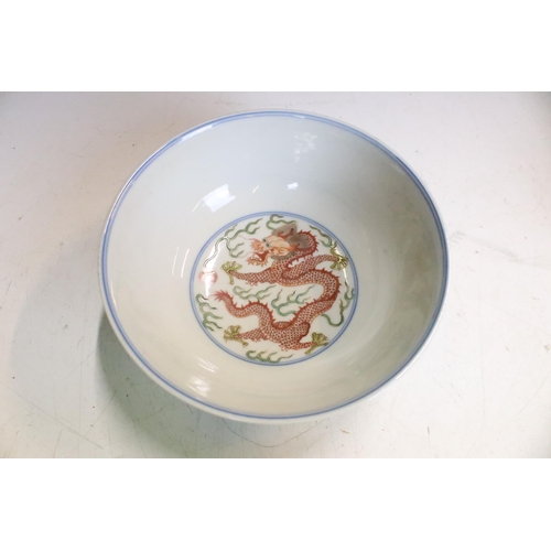 47 - Pair of Chinese Guangxu Wucai white porcelain bowls each being hand enamelled with dragons chasing f... 