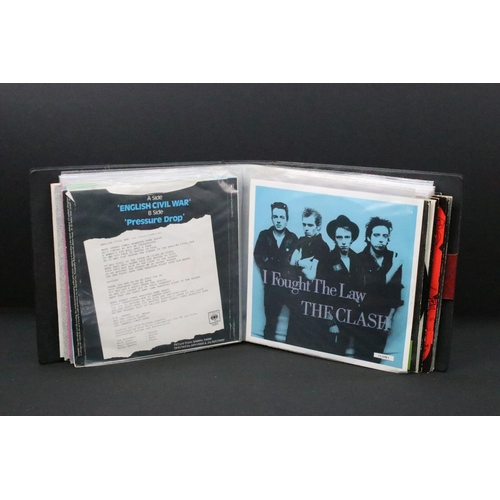 1028 - Vinyl - 18 The Clash 7” singles spanning their career including foreign pressings in folder, to incl... 