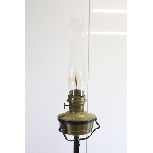 612 - Tall wrought iron and brass oil lamp floor light with glass chimney, H 190cm