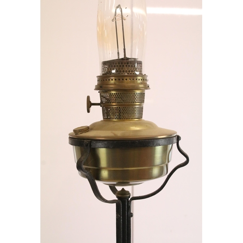 612 - Tall wrought iron and brass oil lamp floor light with glass chimney, H 190cm