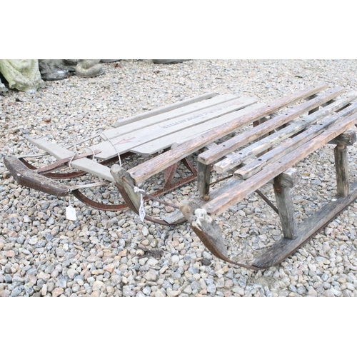 541 - Pair of vintage slatted wood sledges / sleighs including one American flyer example.