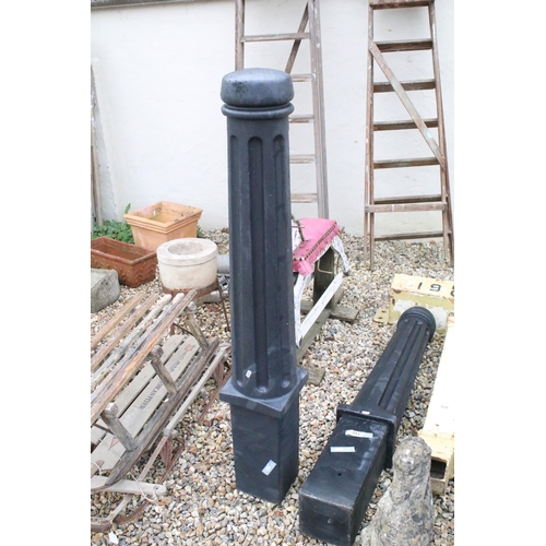 551 - Pair of cast plastic bollards with reeded columns. Measures approx 135cm tall.