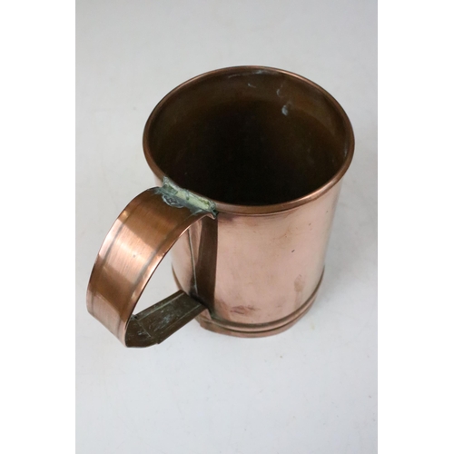 135 - Set of three copper graduating measuring tankards with loop handles, largest 14cm high