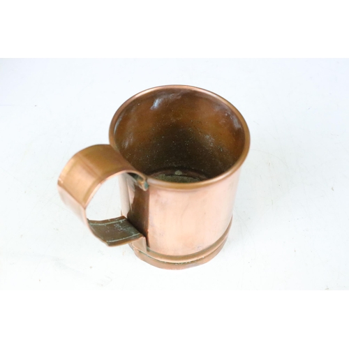 135 - Set of three copper graduating measuring tankards with loop handles, largest 14cm high