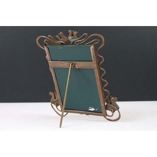 138 - Art Nouveau copper picture photograph frame with flower and ribbon detailed surround, having a stand... 