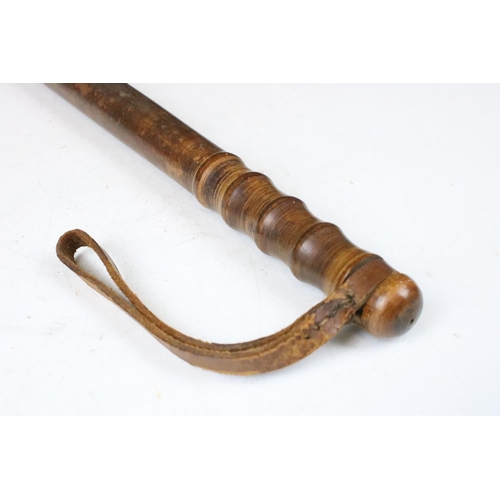 139 - Wooden truncheon with leather strap c. WWII, length 37cm