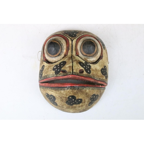 148 - Two mid 20th century folk art tribal wooden hand painted frog masks with articulated jaws, H 17cm