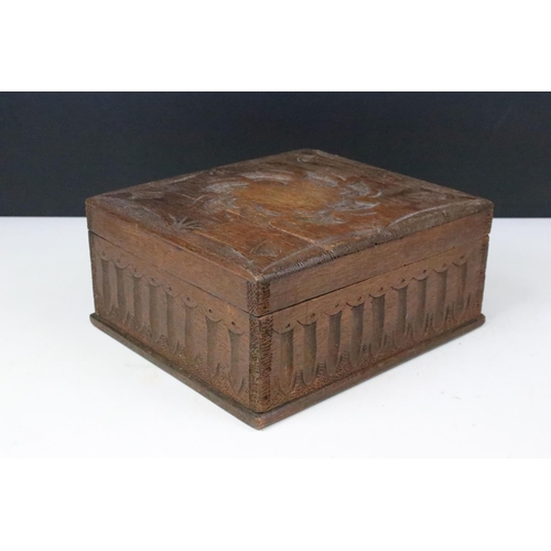 174 - Oak carved wooden box containing a large collection of glass marbles, box measures 15cm wide