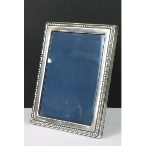 203 - A fully hallmarked sterling silver easel back photograph frame by Robert Carrs of Sheffield together... 