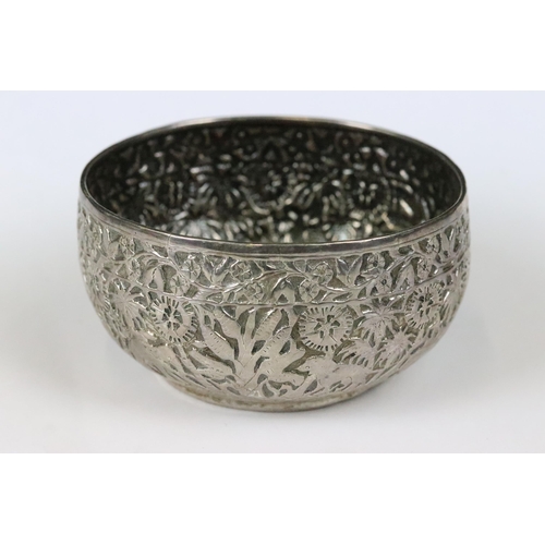 206 - A Indian silver / white metal bowl with repousse decoration featuring wild animals.