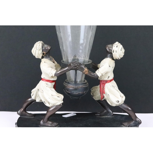 215 - A colonial style Blackamore ornamental table centrepiece with conical glass vase.