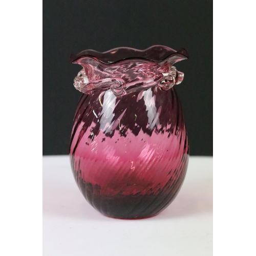 257 - An early 20th century cranberry glass vase together with an enamel egg trinket box on stand.