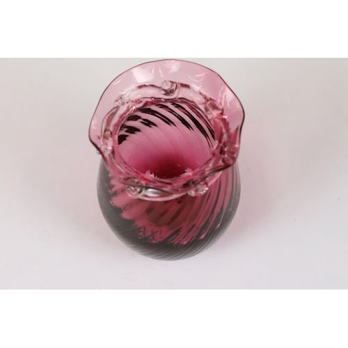 257 - An early 20th century cranberry glass vase together with an enamel egg trinket box on stand.