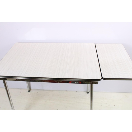 573 - Vintage 1970s Tavo formica topped dining table and chairs having a chrome tubular legs in a white an... 