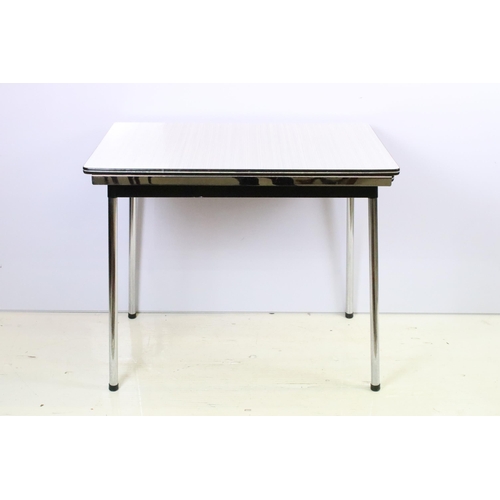 573 - Vintage 1970s Tavo formica topped dining table and chairs having a chrome tubular legs in a white an... 