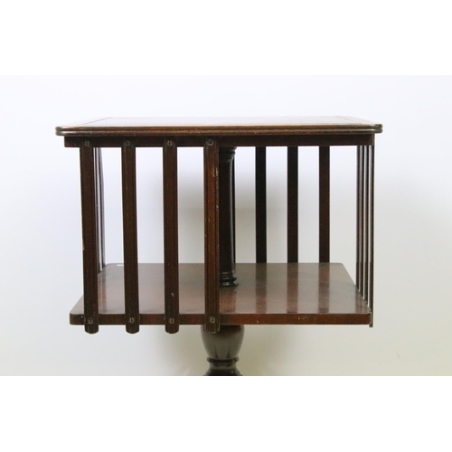 575 - 20th century mahogany revolving bookcase with leatherette inset top and quadruped base, 57cm high x ... 