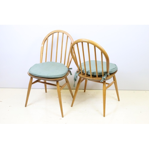 581 - Group of four vintage mid 20th Century light Ercol hoop back dining chairs, raised on turned legs un... 