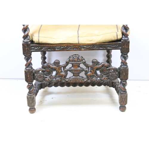 582 - Edwardian carved oak gothic revival open arm chair having carved and pierced back rest with caned ce... 