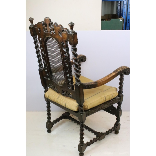 582 - Edwardian carved oak gothic revival open arm chair having carved and pierced back rest with caned ce... 