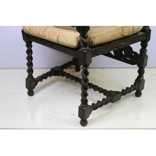 582 - Edwardian carved oak gothic revival open arm chair having carved and pierced back rest with caned ce... 