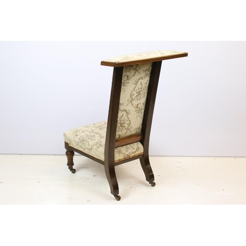 587 - 19th Century Victorian nursing chair having a mahogany frame with over stuffed seat, raised on ceram... 