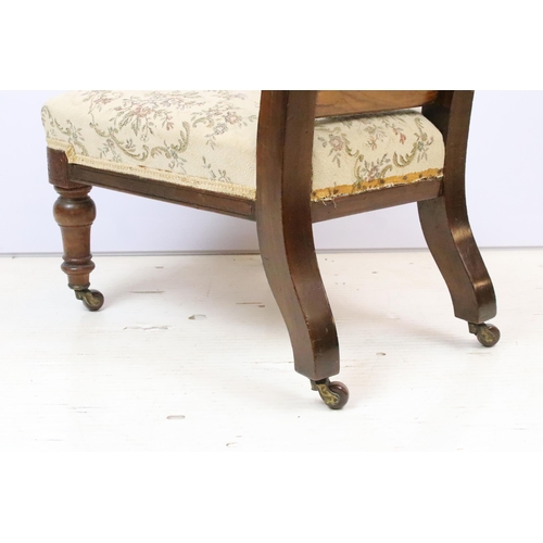 587 - 19th Century Victorian nursing chair having a mahogany frame with over stuffed seat, raised on ceram... 