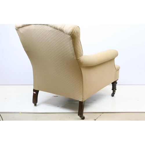 588 - Victorian framed arm chair with later upholstery raised on ceramic castors. the chair having a butto... 