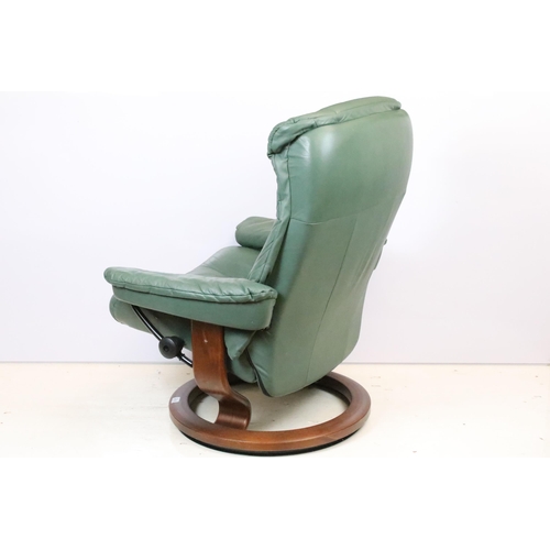 589 - Ekornes Stressless green leather arm chair with matching footstool. Measures 100 x 84 x 70cm.