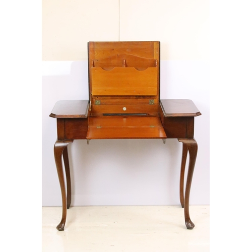 593 - Early 20th century metamorphic Britisher mahogany writing table, with maker's plaque - '