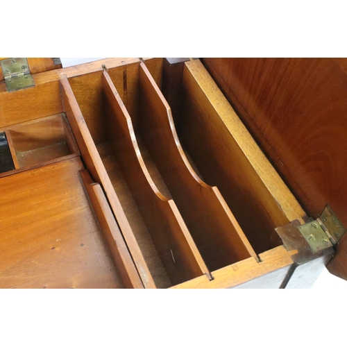 593 - Early 20th century metamorphic Britisher mahogany writing table, with maker's plaque - '