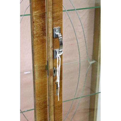 596 - Art Deco walnut veneered two door cabinet, with etched glass doors, with two glass shelves, with key... 