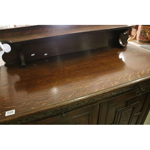 598 - 20th century oak sideboard, with galleried shelf back, above carved frieze drawer and a pair of carv... 