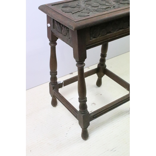 602 - Early 20th century oak stool, the top carved with thistles on turned legs and stretchered base, 61cm... 