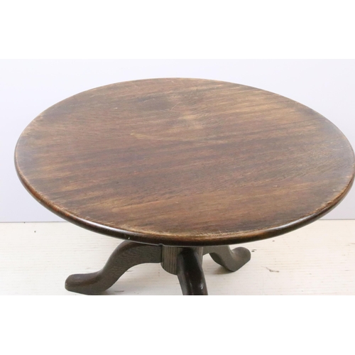 608 - 20th century oak circular occasional table of low form, on turned support and tripod base, 47cm high... 