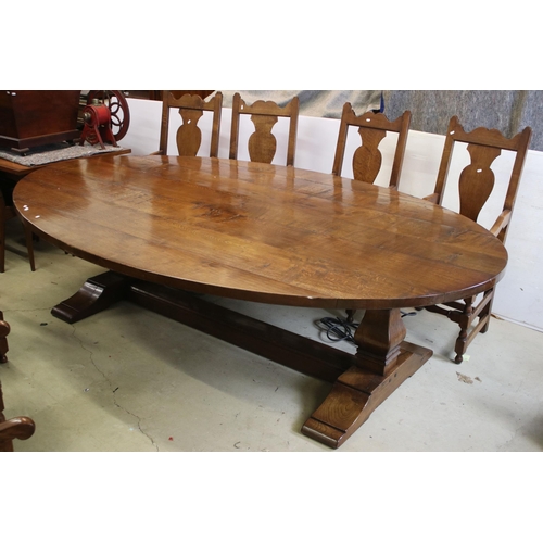 622 - Bylaw The Furniture Makers oval oak refectory table with ten chairs, the planked top, above substant... 