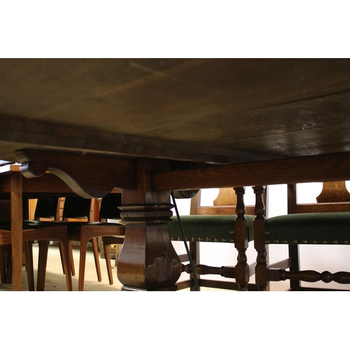 622 - Bylaw The Furniture Makers oval oak refectory table with ten chairs, the planked top, above substant... 