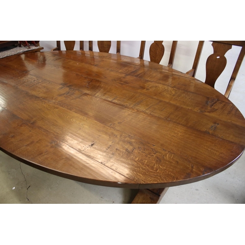 622 - Bylaw The Furniture Makers oval oak refectory table with ten chairs, the planked top, above substant... 