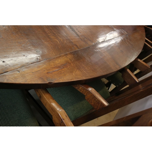 622 - Bylaw The Furniture Makers oval oak refectory table with ten chairs, the planked top, above substant... 