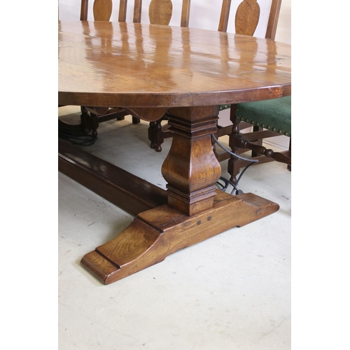 622 - Bylaw The Furniture Makers oval oak refectory table with ten chairs, the planked top, above substant... 