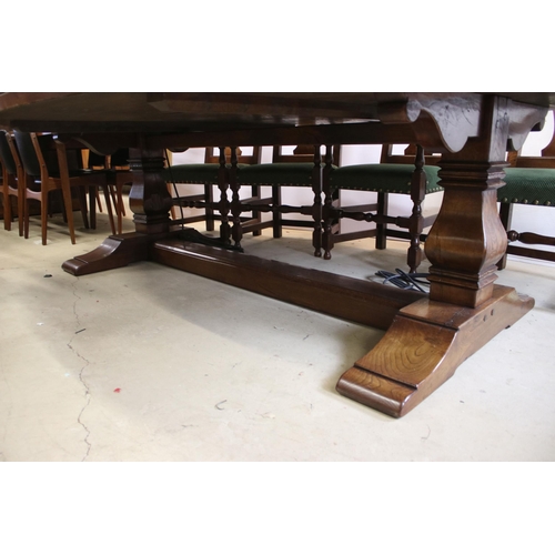 622 - Bylaw The Furniture Makers oval oak refectory table with ten chairs, the planked top, above substant... 