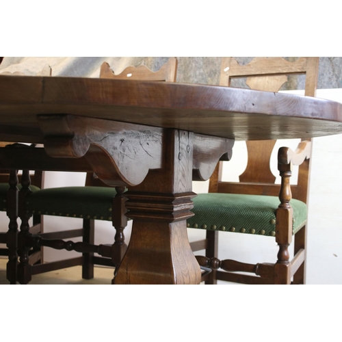 622 - Bylaw The Furniture Makers oval oak refectory table with ten chairs, the planked top, above substant... 