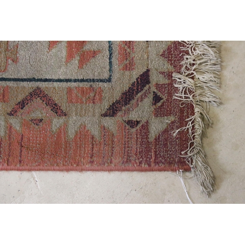 578 - Terracotta ground woollen rug with geometric central design and borders, 232 x 160cm