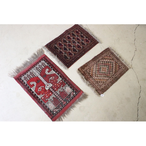 595 - Red ground prayer mat with geometric design, 74 x 60.5cm and two other prayer mats (3)