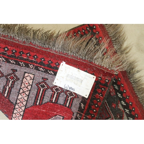 595 - Red ground prayer mat with geometric design, 74 x 60.5cm and two other prayer mats (3)